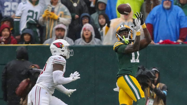 Green Bay Packers receiver Jayden Reed catches a touchdown pass against former Packers linebacker Krys Barnes of the Cardinals on Sunday.