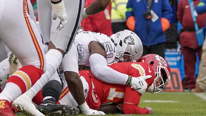 Dec 25, 2023; Kansas City, Missouri, USA; Kansas City Chiefs quarterback Patrick Mahomes (15) is sacked by Las Vegas Raiders defensive end Malcolm Koonce (51) during the first half at GEHA Field at Arrowhead Stadium. Mandatory Credit: Denny Medley-USA TODAY Sports