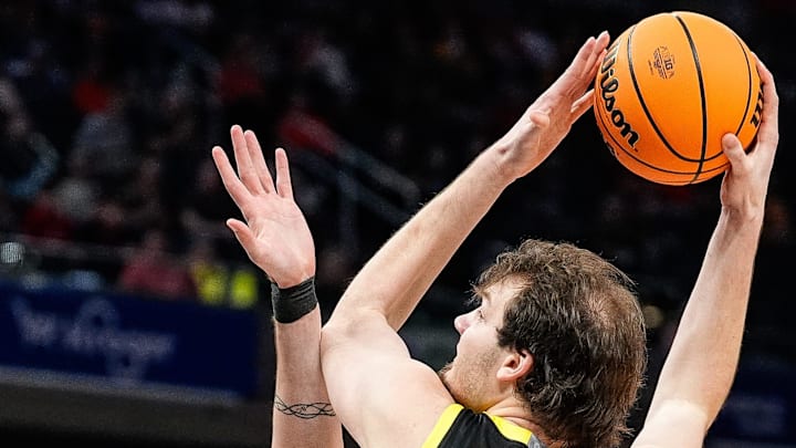 Nate Bittle works for a shot over Michigan State's Carson Cooper. Bittle riddled the Spartans for 22 points and 11 rebounds, but the rest of Oregon's offense struggled against the pressure defense at the Gainbridge Fieldhouse.