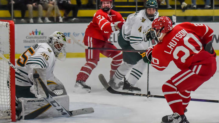 UVM's goalie, Gabe Carriere makes a blocker save on Boston University's Lane Hutson during the