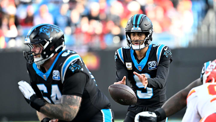 Nov 24, 2024; Charlotte, North Carolina, USA; Carolina Panthers quarterback Bryce Young (9) gets the snap as guard Cade Mays (64) blocks in the third quarter at Bank of America Stadium. 