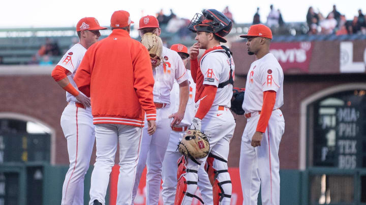 Aug 13, 2024; San Francisco, California, USA; San Francisco Giants pitching coach Bryan Price (80) visits the mound to speak with pitcher Kyle Harrison (45) during the second inning against the Atlanta Braves at Oracle Park. Aug 13, 2024; San Francisco, California, USA; San Francisco Giants pitching coach Bryan Price (80) visits the mound to speak with pitcher Kyle Harrison (45) during the second inning against the Atlanta Braves at Oracle Park.