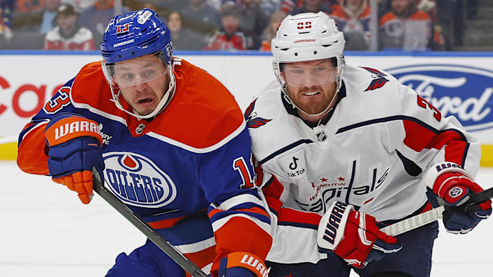 Jan 24, 2026; Edmonton, Alberta, CAN; Edmonton Oilers forward Mattias Janmark (13) and Washington Capitals defensemen Rasmus Sandin (38) chase a loose puck during the first period at Rogers Place. Mandatory Credit: Perry Nelson-Imagn Images
