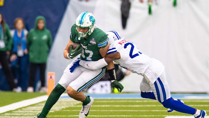 Dec 2, 2023; New Orleans, LA, USA; Tulane Green Wave tight end Alex Bauman (87) runs with the ball against Southern Methodist Mustangs safety Isaiah Nwokobia (23) during the first half at Yulman Stadium. Mandatory Credit: Stephen Lew-Imagn Images