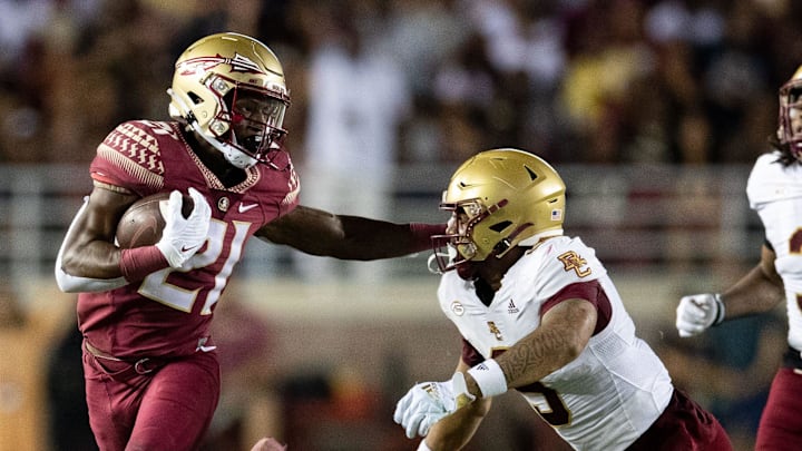 Florida State Seminoles wide receiver Darion Williamson (21) pushes back a defender as he makes his