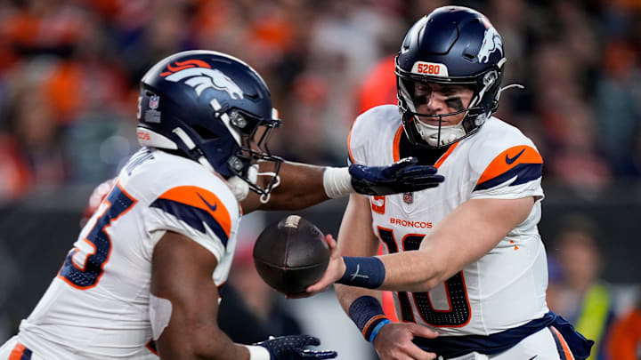 Denver Broncos quarterback Bo Nix (10) hands off to running back Audric Estime (23) in the second quarter of the NFL Week 17 game between the Cincinnati Bengals and the Denver Broncos at Paycor Stadium in downtown Cincinnati on Saturday, Dec. 28, 2024.