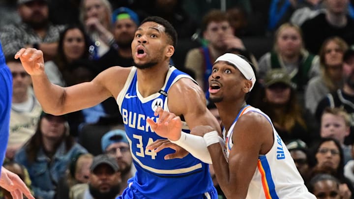 Mar 16, 2025; Milwaukee, Wisconsin, USA;  Milwaukee Bucks forward Giannis Antetokounmpo (34) and Oklahoma City Thunder guard Shai Gilgeous-Alexander (2) jostles for position under the basket in the second quarter at Fiserv Forum. Mandatory Credit: Benny Sieu-Imagn Images
