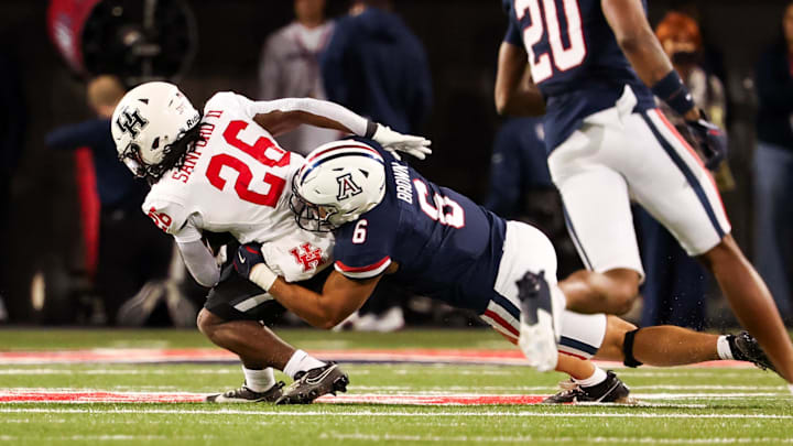 Nov 15, 2024; Tucson, Arizona, USA; Arizona Wildcats linebacker Taye Brown (6) tackles Houston Cougars running back Re’Shaun Sanford II (26) during the third quarter at Arizona Stadium. Mandatory Credit: Aryanna Frank-Imagn Images
