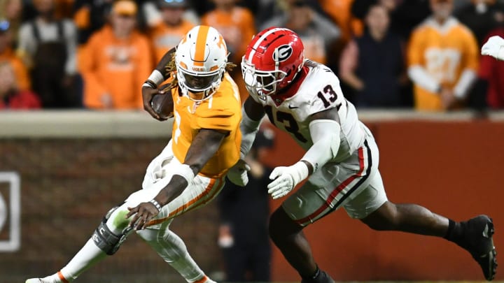 Tennessee quarterback Joe Milton III (7) is defended by Georgia defensive lineman Mykel Williams (13) during a football game between Tennessee and Georgia at Neyland Stadium in Knoxville, Tenn., on Saturday, Nov. 18, 2023.