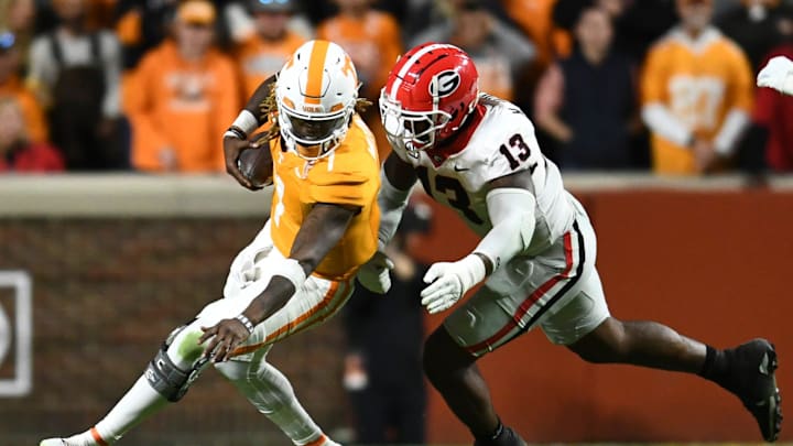 Tennessee quarterback Joe Milton III (7) is defended by Georgia defensive lineman Mykel Williams (13) during a football game between Tennessee and Georgia at Neyland Stadium in Knoxville, Tenn., on Saturday, Nov. 18, 2023.