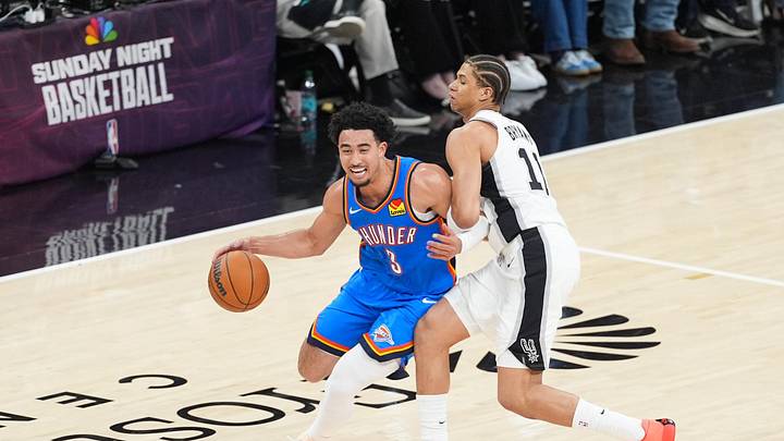 May 24, 2026; San Antonio, Texas, USA; Oklahoma City Thunder guard Jared McCain (3) drives the ball past San Antonio Spurs forward Carter Bryant (11) in the third quarter during game four of the western conference finals for the 2026 NBA playoffs at Frost Bank Center. Mandatory Credit: Daniel Dunn-Imagn Images May 24, 2026; San Antonio, Texas, USA; Oklahoma City Thunder guard Jared McCain (3) drives the ball past San Antonio Spurs forward Carter Bryant (11) in the third quarter during game four of the western conference finals for the 2026 NBA playoffs at Frost Bank Center. Mandatory Credit: Daniel Dunn-Imagn Images
