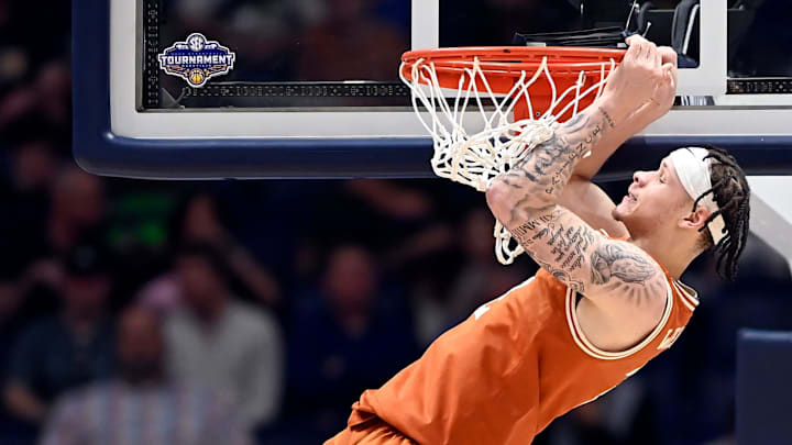 Texas guard Chendall Weaver (2) hangs on the rim after basket by a teammate against Vanderbilt during a NCAA college basketball first round game at the men’s Southeastern Conference Tournament Wednesday, March 12, 2025, in Nashville, Tenn. Texas guard Chendall Weaver (2) hangs on the rim after basket by a teammate against Vanderbilt during a NCAA college basketball first round game at the men’s Southeastern Conference Tournament Wednesday, March 12, 2025, in Nashville, Tenn.