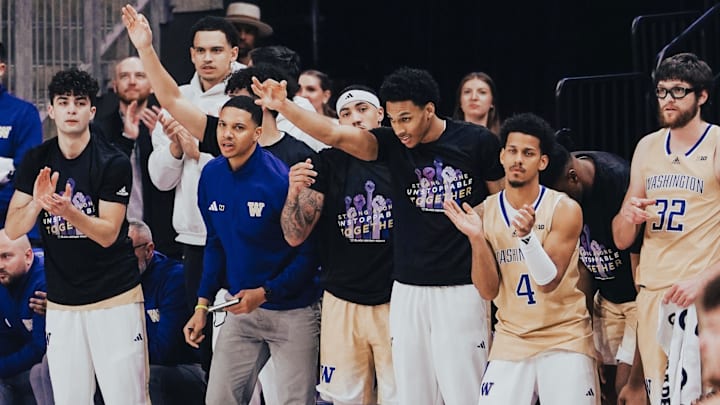 DJ Davis (4), Chris Conway, white sweatshirt, and Dominigue Diomande, arm raised, haven't been available for the UW. 