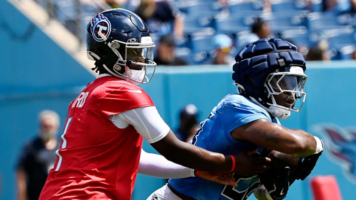Tennessee Titans quarterback Cam Ward (1) hands the ball off to running back Kalel Mullings (28) during “Back Together Weekend” training camp practice at Nissan Stadium Saturday, July 26, 2025, in Nashville, Tenn. Tennessee Titans quarterback Cam Ward (1) hands the ball off to running back Kalel Mullings (28) during “Back Together Weekend” training camp practice at Nissan Stadium Saturday, July 26, 2025, in Nashville, Tenn.
