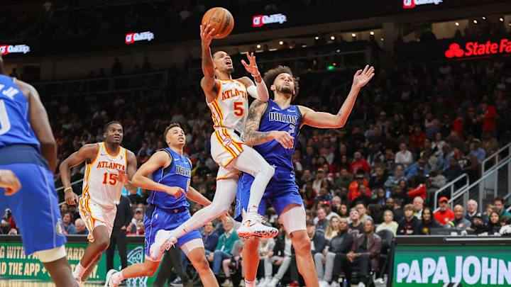 Jan 26, 2024; Atlanta, Georgia, USA; Atlanta Hawks guard Dejounte Murray (5) shoots past Dallas