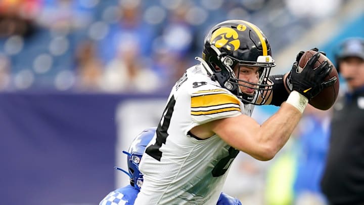 Iowa tight end Sam LaPorta (84) is brought down by Kentucky defensive back Keidron Smith (1) during