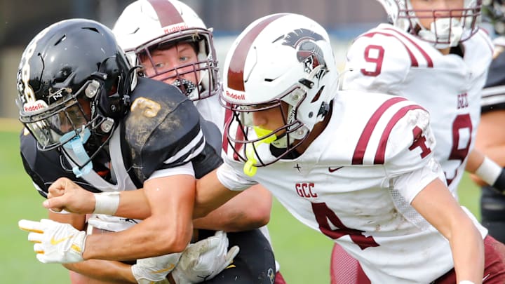 Riverview wide receiver Rio Stotts shields the ball from being punched out by Greensburg Central Catholic's Blase Bugosh Saturday at Riverside Park in Oakmont. The Raiders won 26-7 to improve to 4-2 on the season.