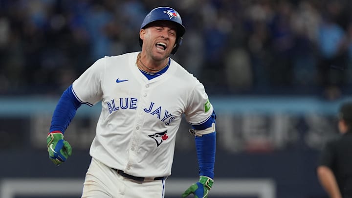 Oct 20, 2025; Toronto, Ontario, CAN; Toronto Blue Jays designated hitter George Springer (4) celebrates after hitting a three-run home run in the seventh inning against the Seattle Mariners during game seven of the ALCS round for the 2025 MLB playoffs at Rogers Centre.