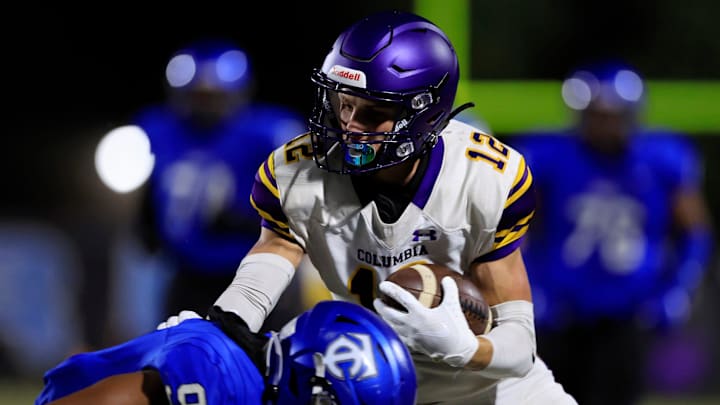 Columbia's Camdon Frier (12) maneuvers past Trinity Christian Academy's Kyle Boylston (9) during the