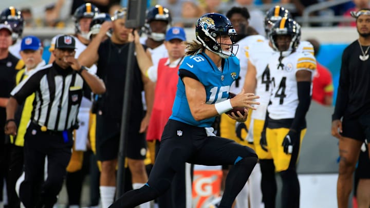 Jacksonville Jaguars quarterback Trevor Lawrence #16 runs out of bounds during the first quarter of