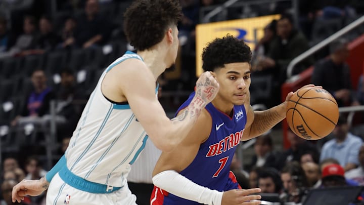 Jan 24, 2024; Detroit, Michigan, USA;  Detroit Pistons guard Killian Hayes (7) dribbles defended by Charlotte Hornets guard LaMelo Ball (1) in the first half at Little Caesars Arena. Mandatory Credit: Rick Osentoski-Imagn Images