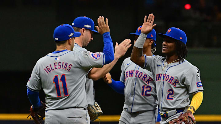 Oct 1, 2024; Milwaukee, Wisconsin, USA; New York Mets second baseman Jose Iglesias (11) and shortstop Luisangel Acuna (2) react after the ninth inning against the Milwaukee Brewers in game one of the Wildcard round for the 2024 MLB Playoffs at American Family Field.
