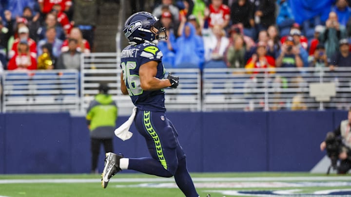Aug 15, 2025; Seattle, Washington, USA; Seattle Seahawks running back Zach Charbonnet (26) rushes for a touchdown against the Kansas City Chiefs during the first quarter at Lumen Field. 