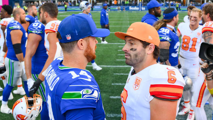 Oct 5, 2025; Seattle, Washington, USA; Seattle Seahawks quarterback Sam Darnold (14) and Tampa Bay Buccaneers quarterback Baker Mayfield (6) meet on the field following a game at Lumen Field. 
