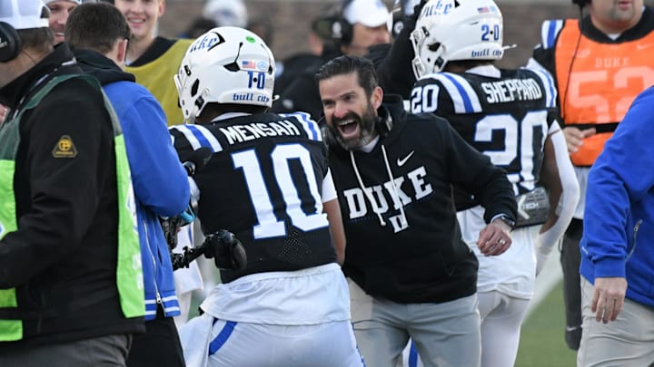 Nov 29, 2025; Durham, North Carolina, USA;  Duke Blue Devils head coach Manny Diaz celebrates Duke Blue Devils quarterback Darian Mensah's (10) touchdown against the Wake Forest Demon Deacons during the second quarter at Wallace Wade Stadium. Mandatory Credit: Zachary Taft-Imagn Images