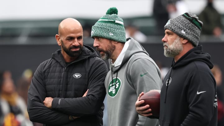 Dec 24, 2023; East Rutherford, New Jersey, USA; New York Jets head coach Robert Saleh (left) talks with quarterback Aaron Rodgers (center) before the game against the Washington Commanders at MetLife Stadium. Dec 24, 2023; East Rutherford, New Jersey, USA; New York Jets head coach Robert Saleh (left) talks with quarterback Aaron Rodgers (center) before the game against the Washington Commanders at MetLife Stadium.