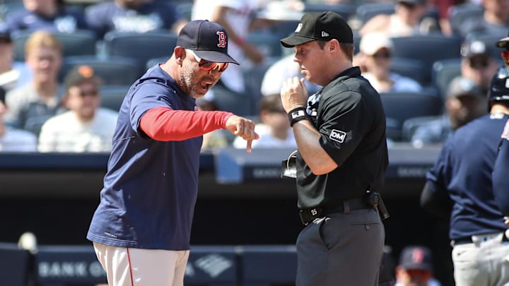 Aug 20, 2023; Bronx, New York, USA;  Boston Red Sox manager Alex Cora (13) argues with home plate umpire Junior Valentine (25) after getting ejected in the sixth inning against the Boston Red Sox at Yankee Stadium. Mandatory Credit: Wendell Cruz-Imagn Images