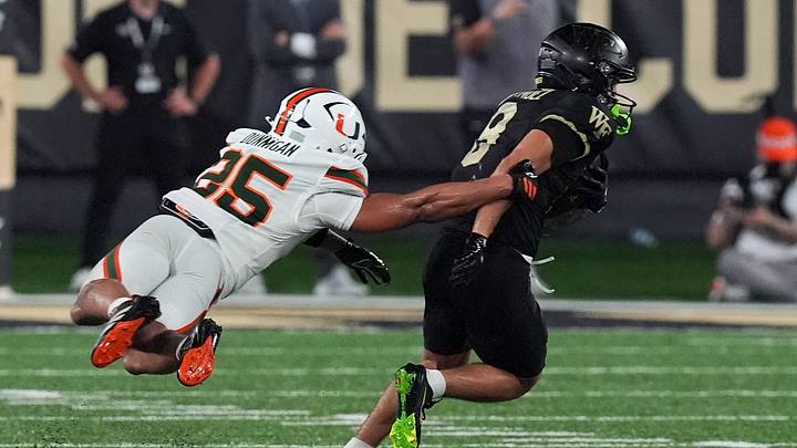 Sep 18, 2026; Winston-Salem, North Carolina, USA;  Miami (FL) Hurricanes defensive back Monroe Toney (35) is airborne trying to tackle Wake Forest Demon Deacons wide receiver Chase Tyler (9) during the second half at Allegacy Federal Credit Union Stadium.  Mandatory Credit: Jim Dedmon-Imagn Images