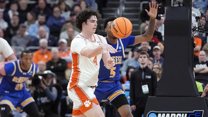 Mar 20, 2025; Providence, RI, USA; Clemson Tigers forward Ian Schieffelin (4) passes th ball against McNeese State Cowboys forward Joe Charles (5) during the first half at Amica Mutual Pavilion. Mandatory Credit: Gregory Fisher-Imagn Images