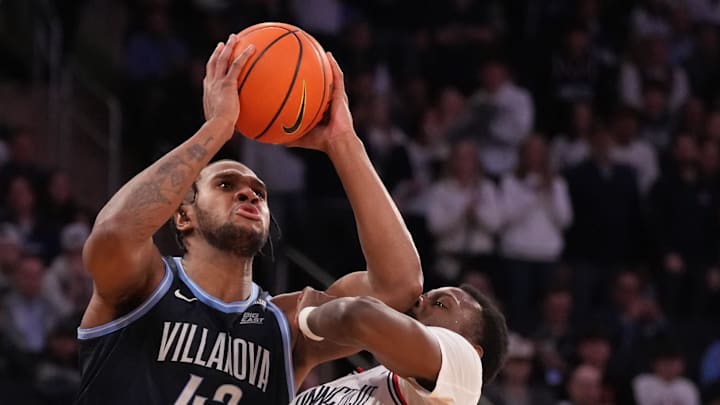 Villanova Wildcats forward Eric Dixon shoots over Connecticut Huskies center Samson Johnson.