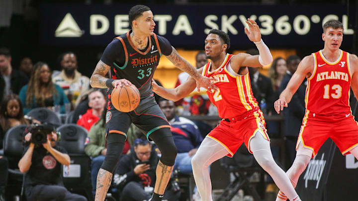 Jan 13, 2024; Atlanta, Georgia, USA; Washington Wizards forward Kyle Kuzma (33) is defended by Atlanta Hawks guard Trent Forrest (2) in the second quarter at State Farm Arena. Mandatory Credit: Brett Davis-USA TODAY Sports