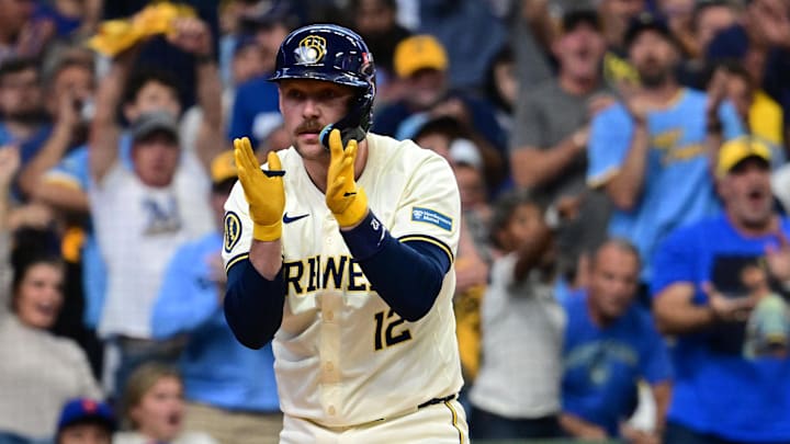 Oct 1, 2024; Milwaukee, Wisconsin, USA; Milwaukee Brewers first base Rhys Hoskins (12) reacts after being hit by a pitch against the New York Mets during the first inning in game one of the Wildcard round for the 2024 MLB Playoffs at American Family Field.