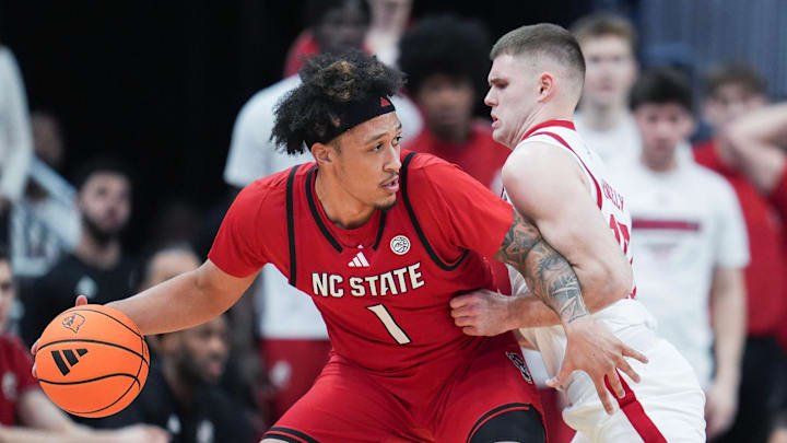 Louisville Cardinals guard Isaac McKneely (10) pressures NC State Wolfpack forward Darrion Williams (1) at the KFC Yum! Center in downtown Louisville February 9, 2026.