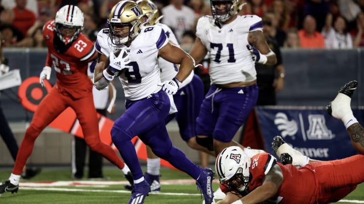 Will Nixon is shown running against Jedd Fisch's Arizona team in 2023.