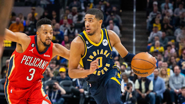 Nov 7, 2022; Indianapolis, Indiana, USA; Indiana Pacers guard Tyrese Haliburton (0) dribbles the ball while New Orleans Pelicans guard CJ McCollum (3) defends in the second half at Gainbridge Fieldhouse. Mandatory Credit: Trevor Ruszkowski-Imagn Images