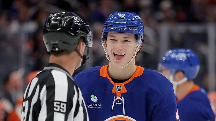 Dec 11, 2025; Elmont, New York, USA; New York Islanders defenseman Matthew Schaefer (48) reacts as he talks to linesman Steve Barton (59) during the second period against the Anaheim Ducks at UBS Arena. Mandatory Credit: Brad Penner-Imagn Images