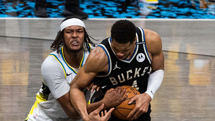 Apr 29, 2025; Indianapolis, Indiana, USA; Indiana Pacers center Myles Turner (33) and Milwaukee Bucks forward Giannis Antetokounmpo (34) fight for the ball  during game five of the first round for the 2024 NBA Playoffs at Gainbridge Fieldhouse. Mandatory Credit: Trevor Ruszkowski-Imagn Images