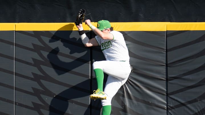 In addition to leading the nation in home runs, Mason Neville (and his outfield partner Anson Aroz can do it with the leather. Here he runs a Michigan player of an extra-base hit at the wall. 