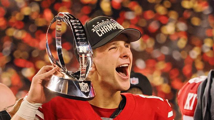 Jan 28, 2024; Santa Clara, California, USA; San Francisco 49ers quarterback Brock Purdy (13) holds the George Halas Trophy while after winning the NFC Championship football game against the Detroit Lions at Levi's Stadium. Mandatory Credit: Kelley L Cox-Imagn Images