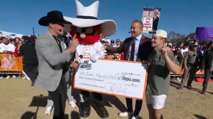 Texas Tech student celebrates winning Pat McAfee’s kicking contest with mascot Raider Red and Kirk Herbstreit.