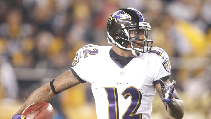 Jan 3, 2015; Pittsburgh, PA, USA; Baltimore Ravens wide receiver Jacoby Jones (12) returns a kick-off against the Pittsburgh Steelers during the first quarter in the 2014 AFC Wild Card playoff football game at Heinz Field. The Ravens won 30-17. Mandatory Credit: Charles LeClaire-Imagn Images