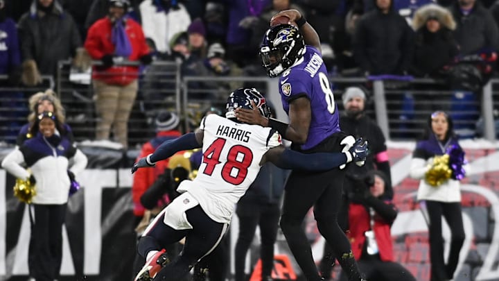 Jan 20, 2024; Baltimore, MD, USA; Baltimore Ravens quarterback Lamar Jackson (8) tries to avoid the pass rush of Houston Texans linebacker Christian Harris (48) during the second quarter of a 2024 AFC divisional round game at M&T Bank Stadium. Mandatory Credit: Tommy Gilligan-Imagn Images