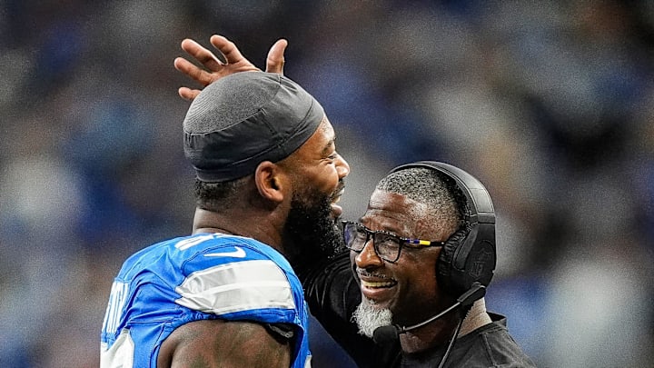 Detroit Lions defensive coordinator Aaron Glenn hugs defensive end Za'Darius Smith (99) after a play against Chicago Bears during the first half at Ford Field in Detroit on Thursday, Nov. 28, 2024.