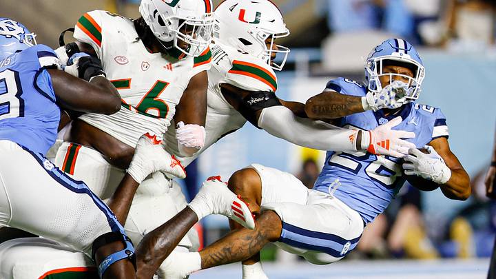 Oct 14, 2023; Chapel Hill, North Carolina, USA; North Carolina Tar Heels running back Omarion Hampton (28) fights for yards as he carries the ball against the Miami Hurricanes in the first half at Kenan Memorial Stadium. Mandatory Credit: Nell Redmond-USA TODAY Sports