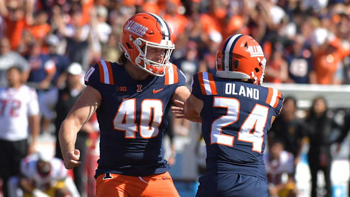 Sep 27, 2025; Champaign, Illinois, USA; Illinois Fighting Illini’s Keelan Crimmins congratulates Illinois Fighting Illini kicker David Olano (24) after kicking the game winning 41-yard field goal to beat Southern California Trojans 34-32 at Memorial Stadium. Mandatory Credit: Ron Johnson-Imagn Images