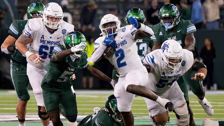Nov 28, 2024; New Orleans, Louisiana, USA; Memphis Tigers running back Mario Anderson Jr. (2) breaks free from several tackle attempts on his way to scoring a touchdown against the Tulane Green Wave during the fourth quarter at Yulman Stadium. Nov 28, 2024; New Orleans, Louisiana, USA; Memphis Tigers running back Mario Anderson Jr. (2) breaks free from several tackle attempts on his way to scoring a touchdown against the Tulane Green Wave during the fourth quarter at Yulman Stadium.